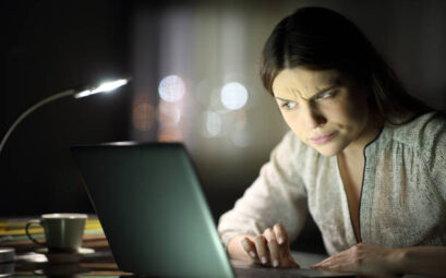 Suspicious Woman Checking Laptop Content In The Night